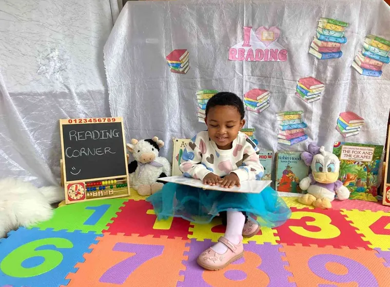 Young learner reading during a classroom activity