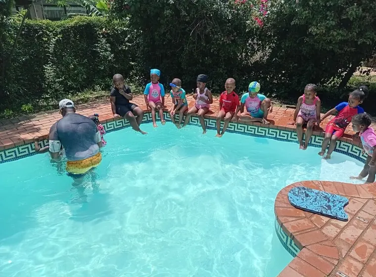 Children participating in a supervised swimming lesson
